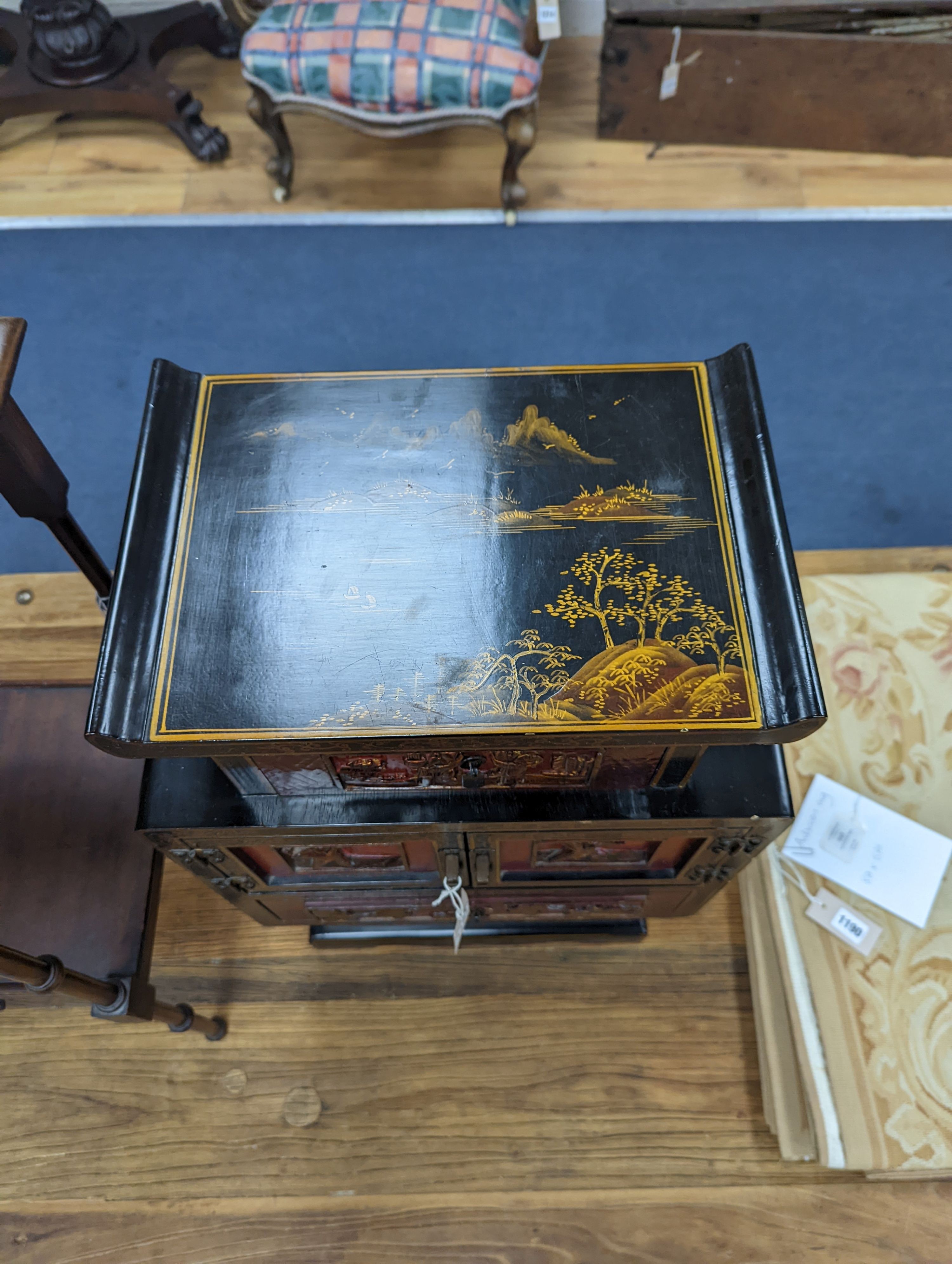 A late 19th century Chinese red and black lacquered cabinet, width 39cm, height 66cm